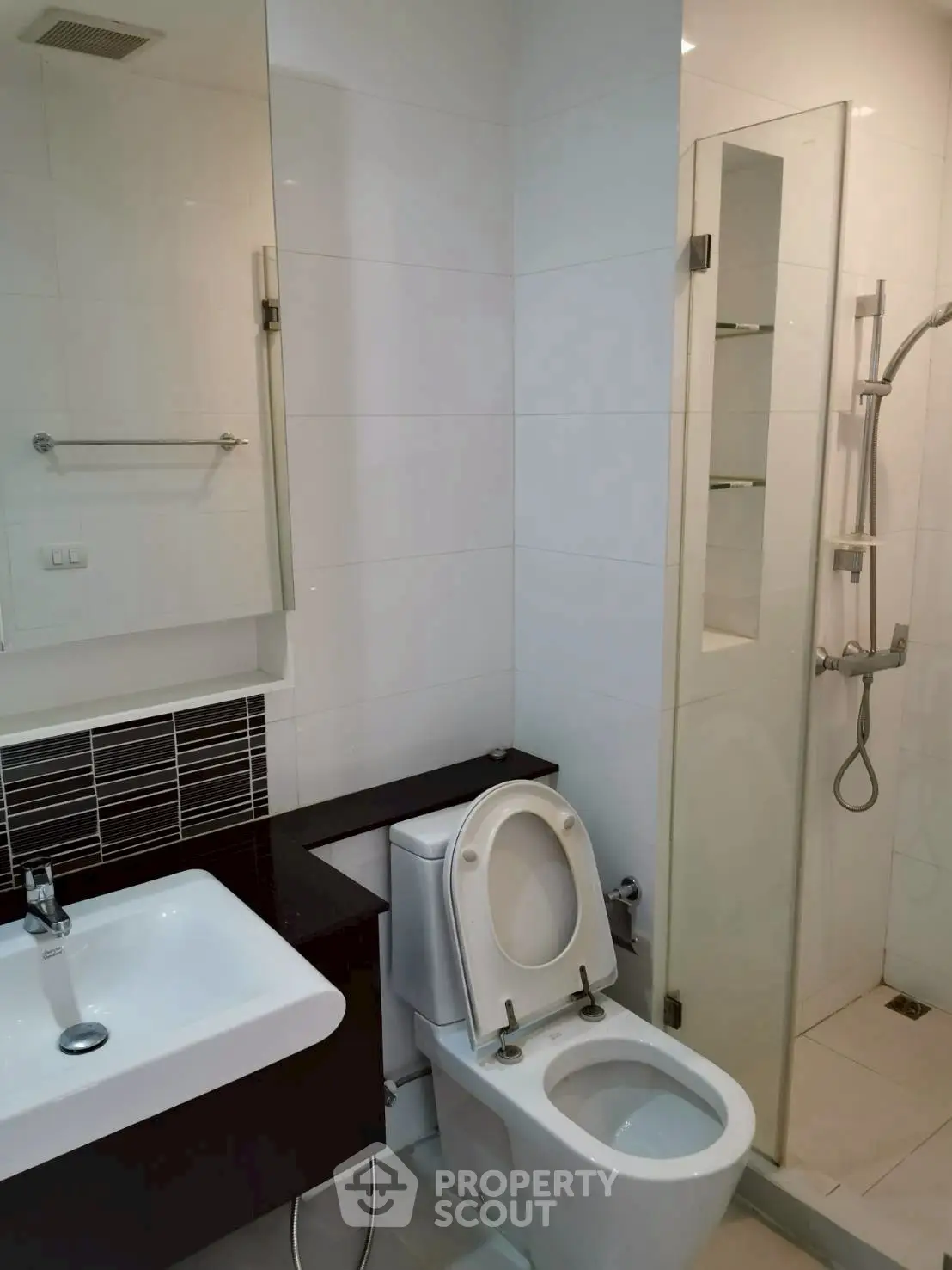 Modern bathroom with sleek fixtures and glass shower enclosure