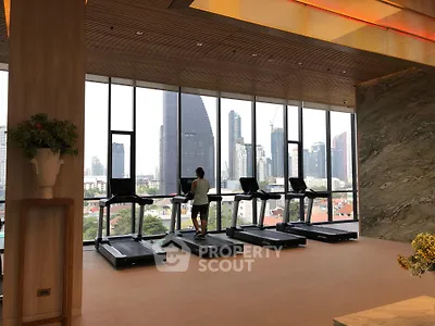 Luxurious gym with city skyline view and modern treadmills in high-rise building