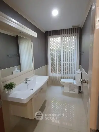 Modern bathroom with sleek fixtures and large window for natural light