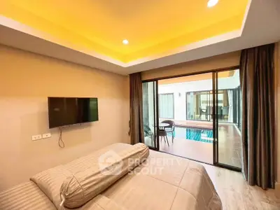 Luxurious bedroom with pool view and modern amenities in a stylish home.