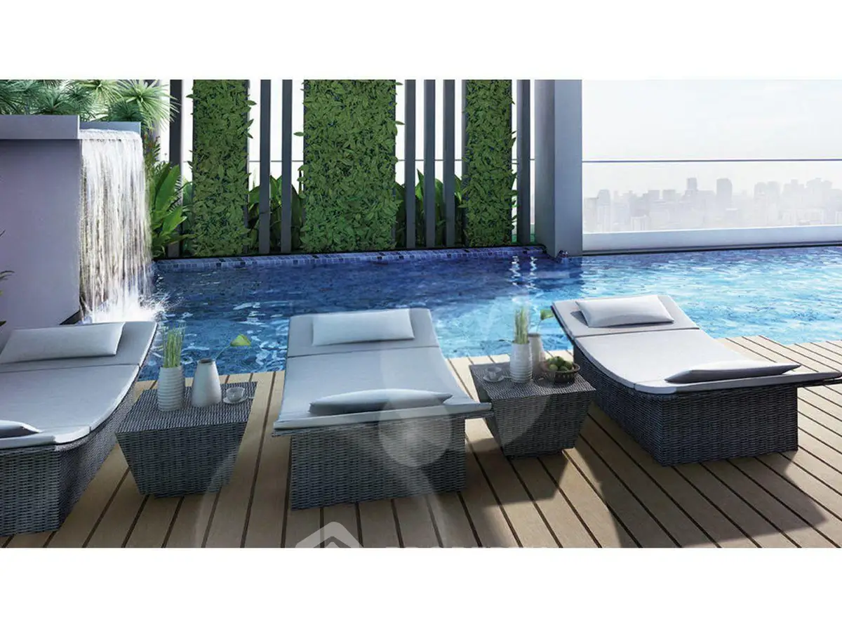 Luxurious rooftop pool with stylish loungers and city skyline view
