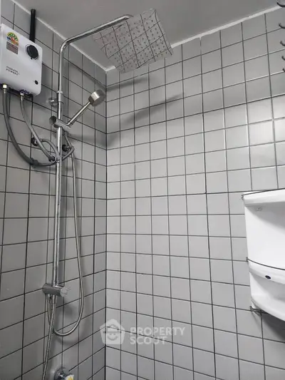 Modern bathroom with tiled walls and sleek shower fixtures
