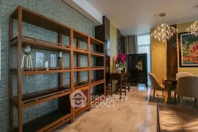 Luxurious living room with elegant decor, featuring modern lighting and stylish furniture in a sophisticated setting.