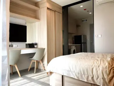 Modern bedroom with study area and built-in wardrobe in a stylish apartment.