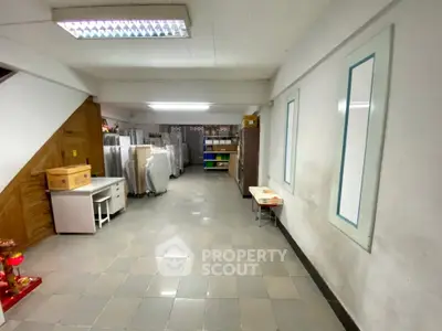 Spacious storage area with tiled flooring and ample shelving, ideal for organizing and storing items efficiently.