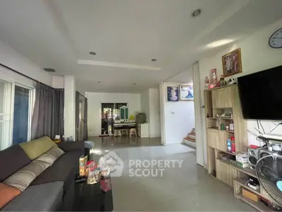 Spacious living room with modern decor and ample natural light