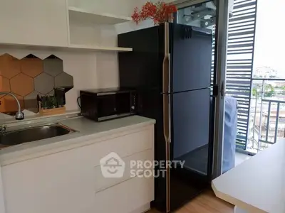 Modern kitchen with sleek appliances and balcony view