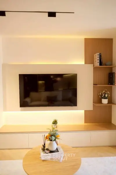 Modern living room with sleek TV setup and stylish shelving, perfect for contemporary living.