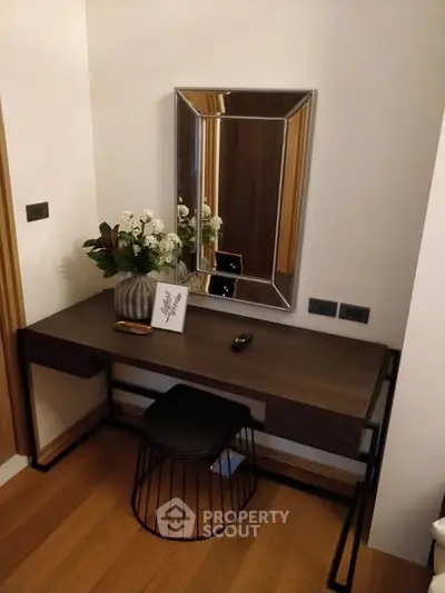Stylish modern study nook with sleek desk, mirror, and elegant decor in a cozy corner.