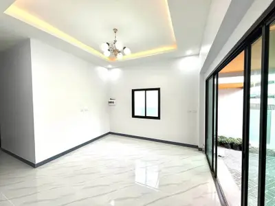Spacious modern living room with elegant lighting and large windows for natural light.