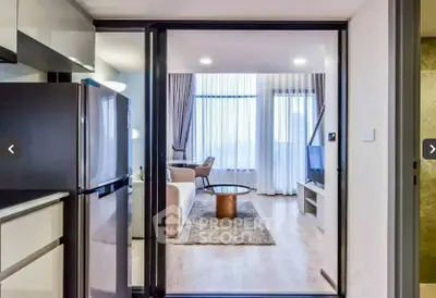 Modern open-layout living room with sleek kitchen and large windows