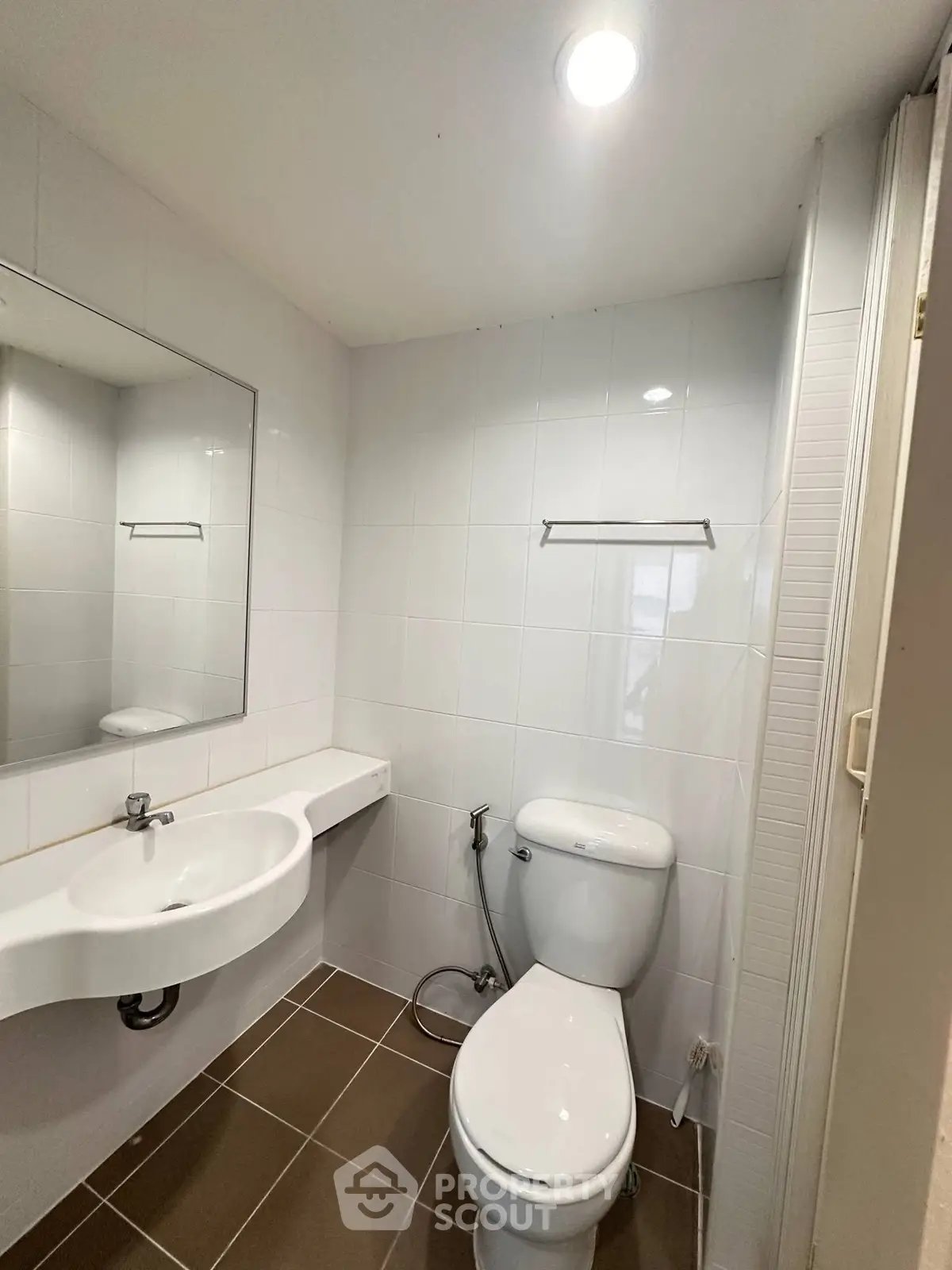 Modern bathroom with white tiles and sleek fixtures