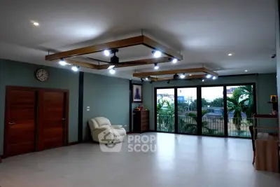 Spacious modern living room with large windows and stylish lighting