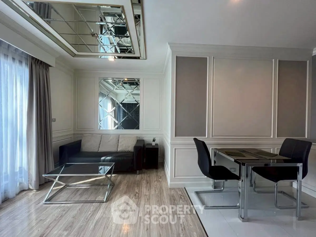 Modern living room with mirrored ceiling and elegant dining area