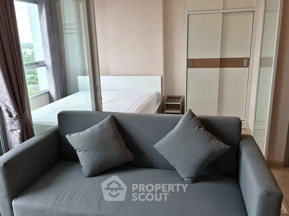Modern apartment interior with cozy living room and bedroom, featuring stylish furniture and natural light.