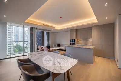 Luxurious open-plan living room with modern kitchen and city view balcony.