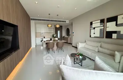 Modern living room with open kitchen, stylish decor, and cozy seating area in a contemporary apartment.
