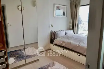 Cozy bedroom with city view and mirrored wardrobe