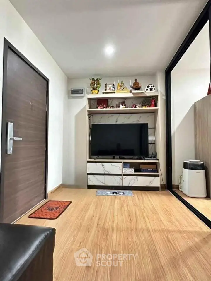 Modern living room with sleek wooden flooring and stylish TV unit