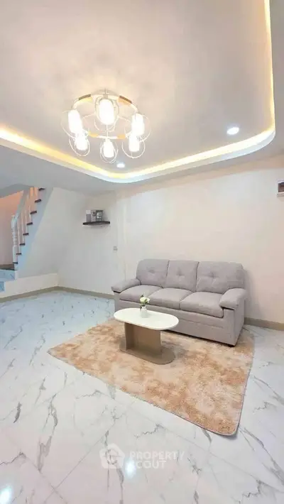 Elegant living room with modern lighting and cozy sofa on marble flooring