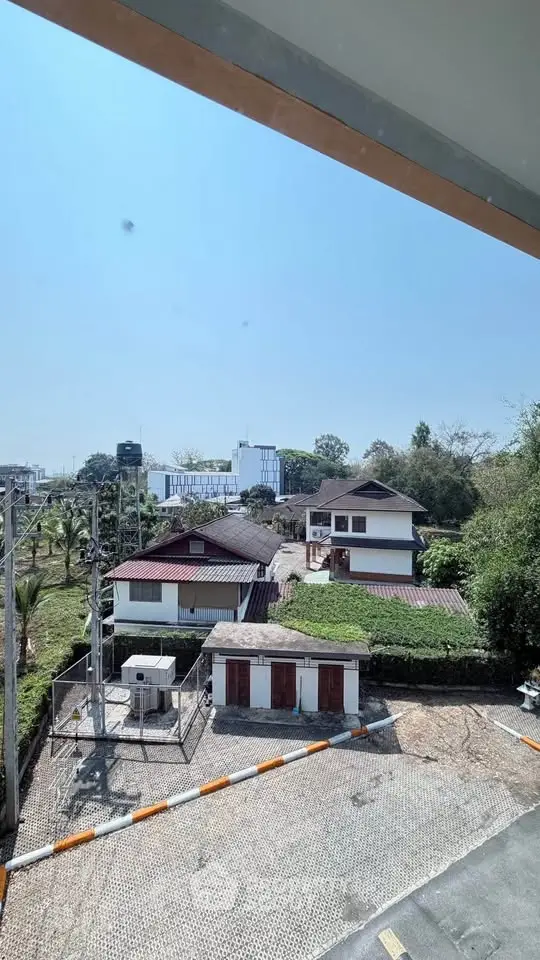 Scenic view of suburban houses with lush greenery and clear blue sky.