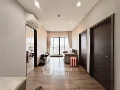 Modern apartment interior with open living area and city view balcony.