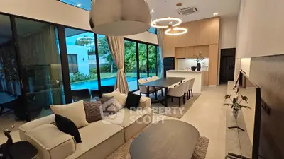 Luxurious open-plan living room with pool view and modern decor