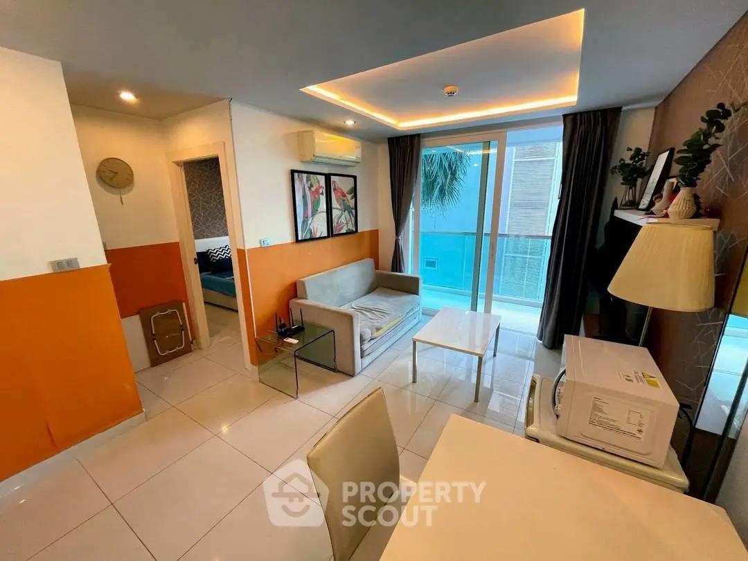 Modern living room with stylish decor and large windows offering natural light.