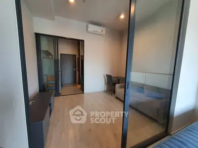 Modern apartment interior with glass partition and sleek furnishings