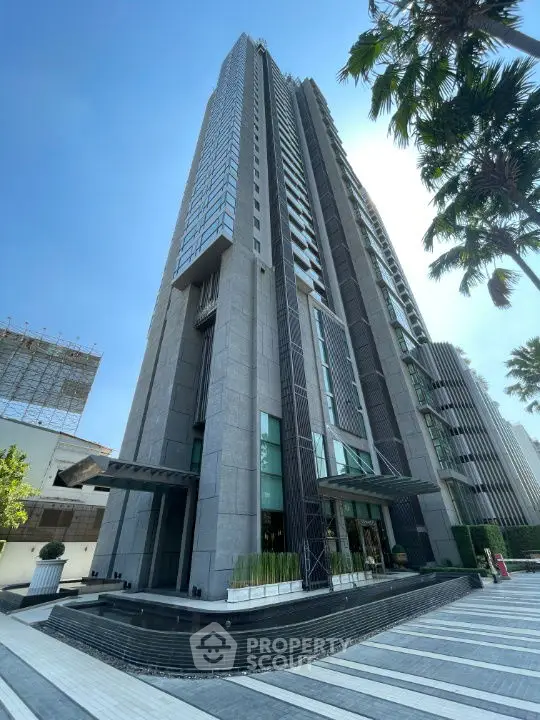 Stunning modern high-rise building with sleek design and lush surroundings.