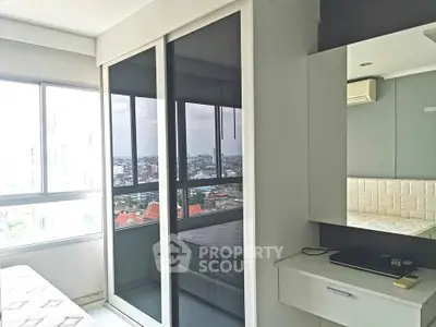 Modern bedroom with city view, featuring sleek wardrobe and stylish decor.