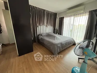 Spacious bedroom with elegant curtains and modern decor