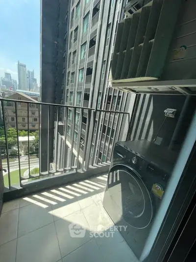 Modern apartment balcony with city view and washing machine setup.