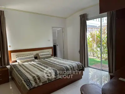 Spacious bedroom with garden view and modern decor