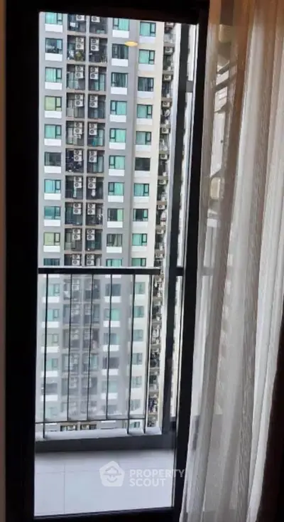 Modern apartment balcony with city view and glass railing, perfect for urban living.