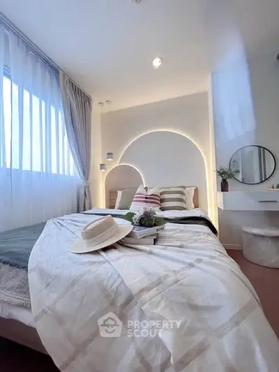 Cozy bedroom with stylish decor and natural light, perfect for relaxation and comfort.