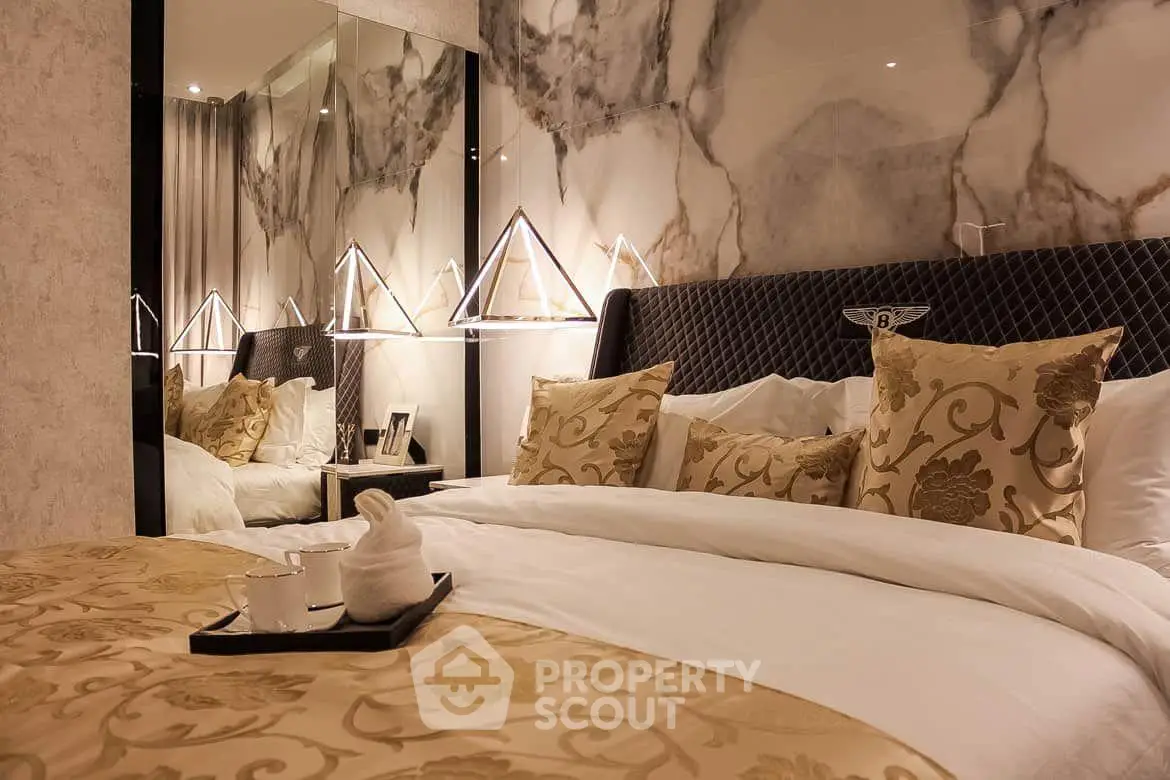 Luxurious bedroom with elegant decor and plush bedding in a modern apartment.