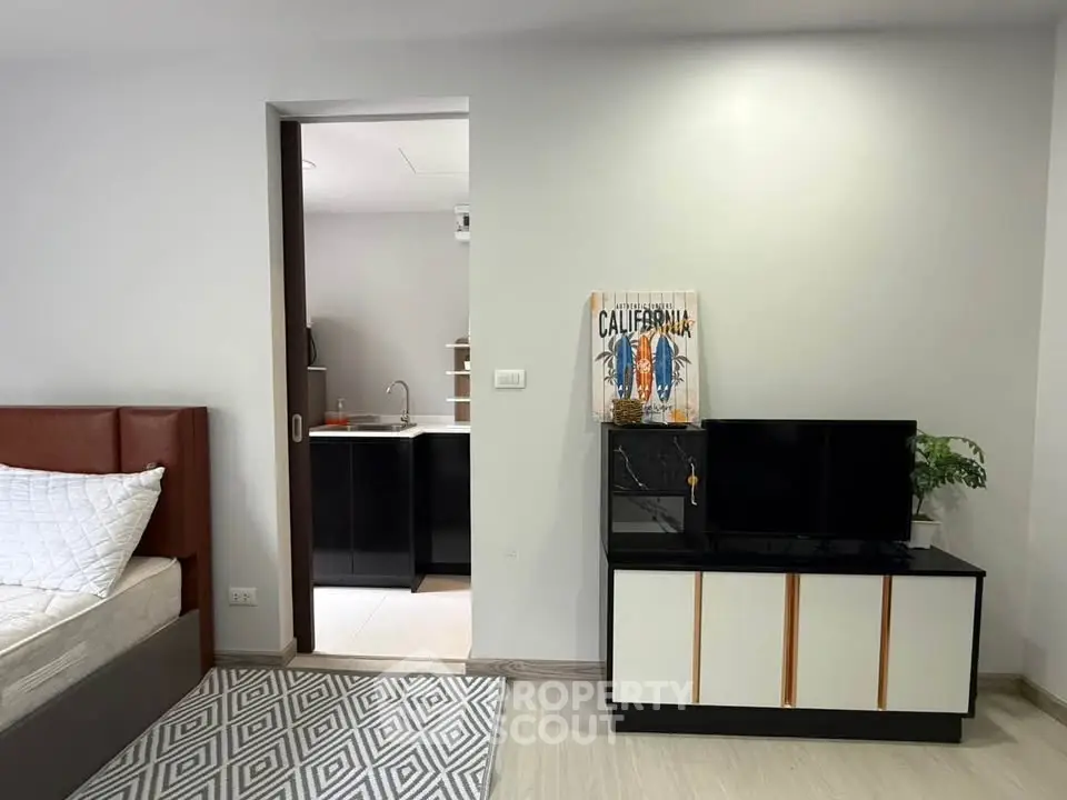 Modern studio apartment with sleek interior design and cozy living space.
