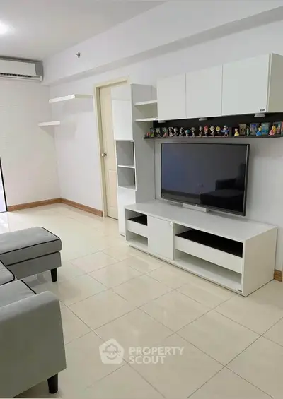 Modern living room with sleek TV unit and cozy sofa