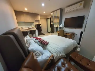 Modern studio apartment with cozy bedroom and open kitchen layout