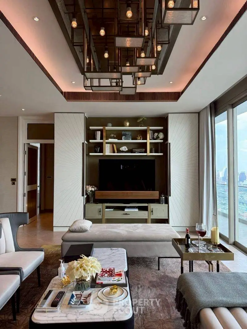 Luxurious living room with modern decor and stunning city view, featuring elegant lighting and stylish furniture.