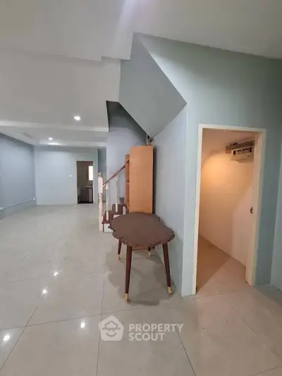 Spacious interior with tiled flooring and staircase, ideal for modern living.