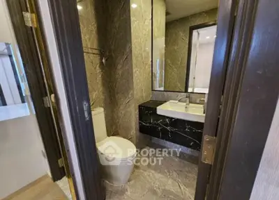 Luxurious modern bathroom with elegant marble finishes and sleek fixtures.