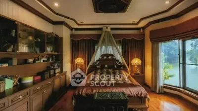 Luxurious bedroom with elegant decor and large windows offering serene views.