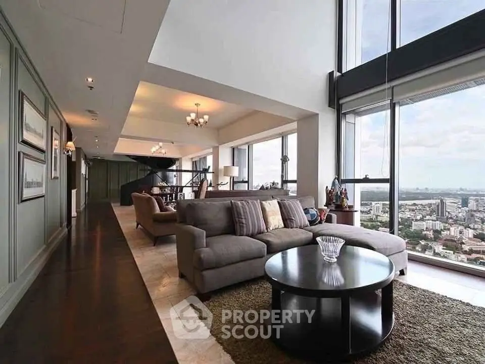 Luxurious penthouse living room with panoramic city views and elegant modern furnishings.