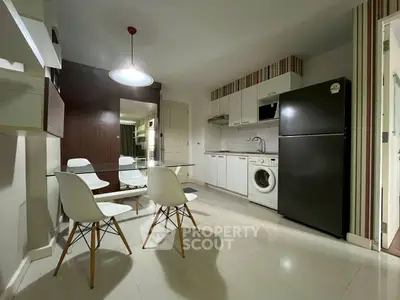Modern kitchen with sleek appliances and dining area in stylish apartment