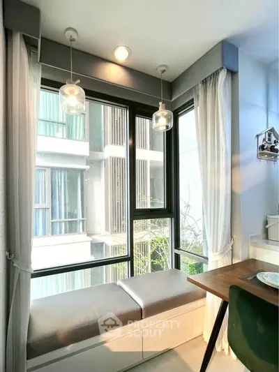 Bright corner unit with large windows and cozy seating area, perfect for relaxation.