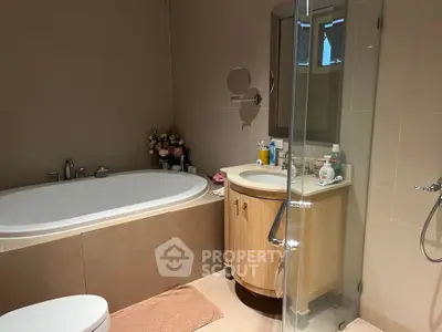 Modern bathroom with elegant bathtub and glass shower enclosure