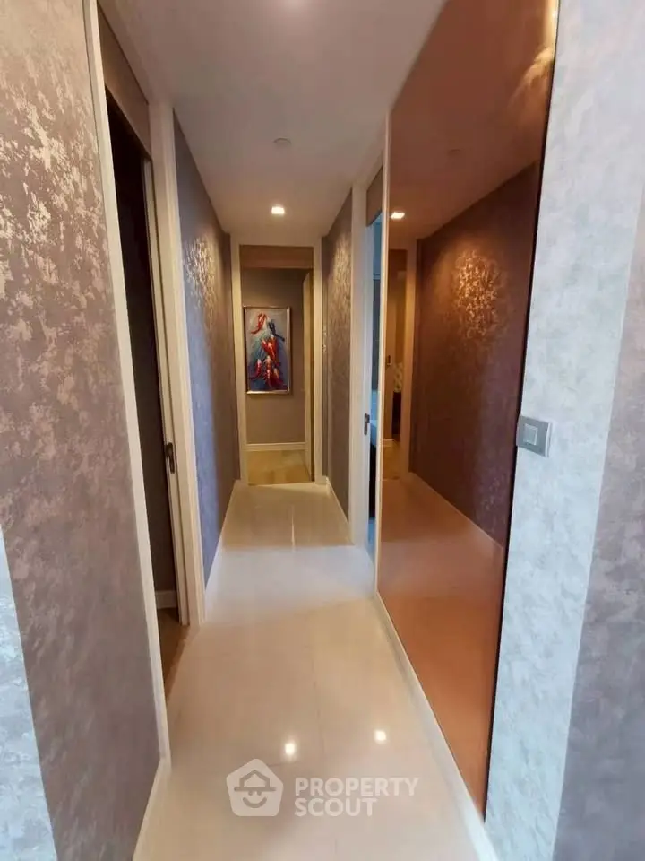 Stylish modern hallway with elegant lighting and artwork, showcasing luxurious interior design.
