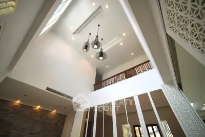 Stunning modern interior with high ceilings and elegant lighting fixtures